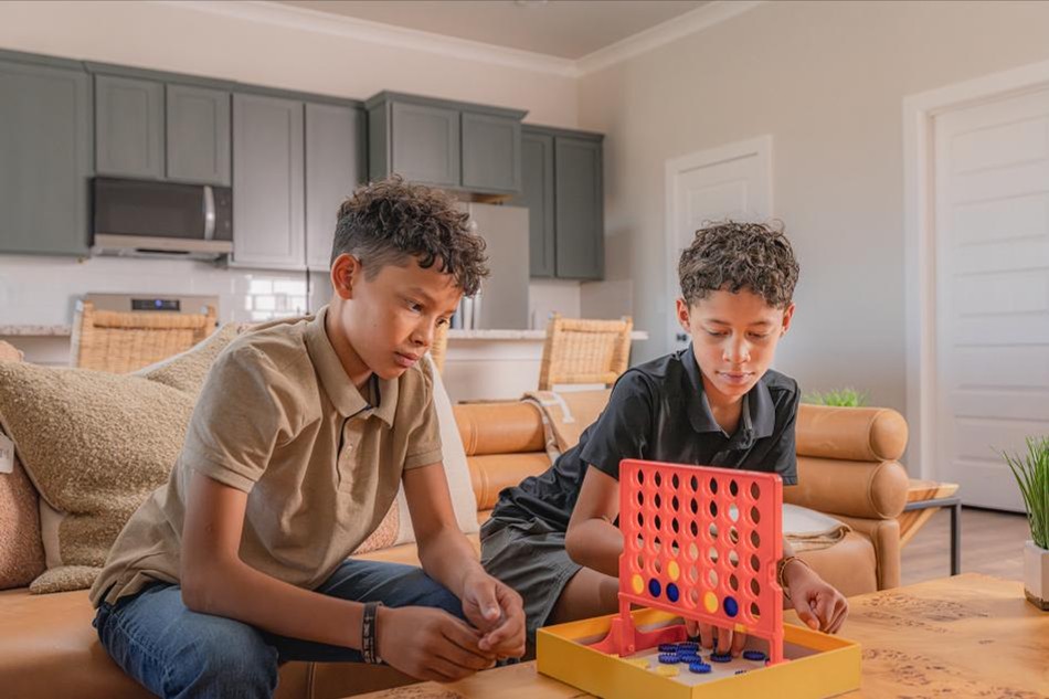 Boys Game Comp Photo of two brothers playing a game in the living room of their Betenbough home.