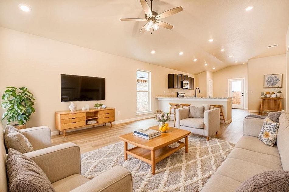 Dorris Interior Comp Photo of a furnished living room and kitchen in the Dorris, a 1,550 sq ft Betenbough Homes floor plan.