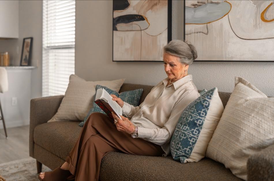 Grandma Reading Photo of a woman reading in her Origin floor plan, a small home by Betenbough Homes.