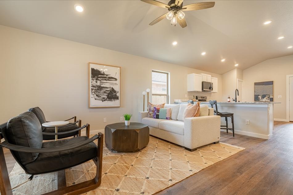 Tanya Interior Comp Photo of a furnished living room and kitchen in the Tanya, a Betenbough Homes floor plan.