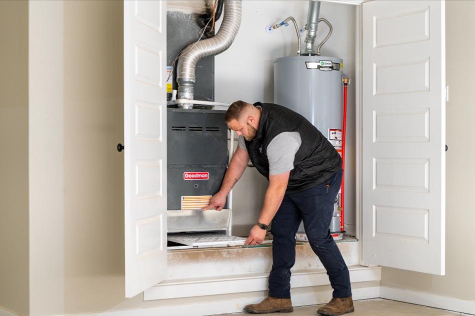 Warranty Comp Photo of a Betenbough Homes warranty technician taking care of a warranty call for a homeowner.