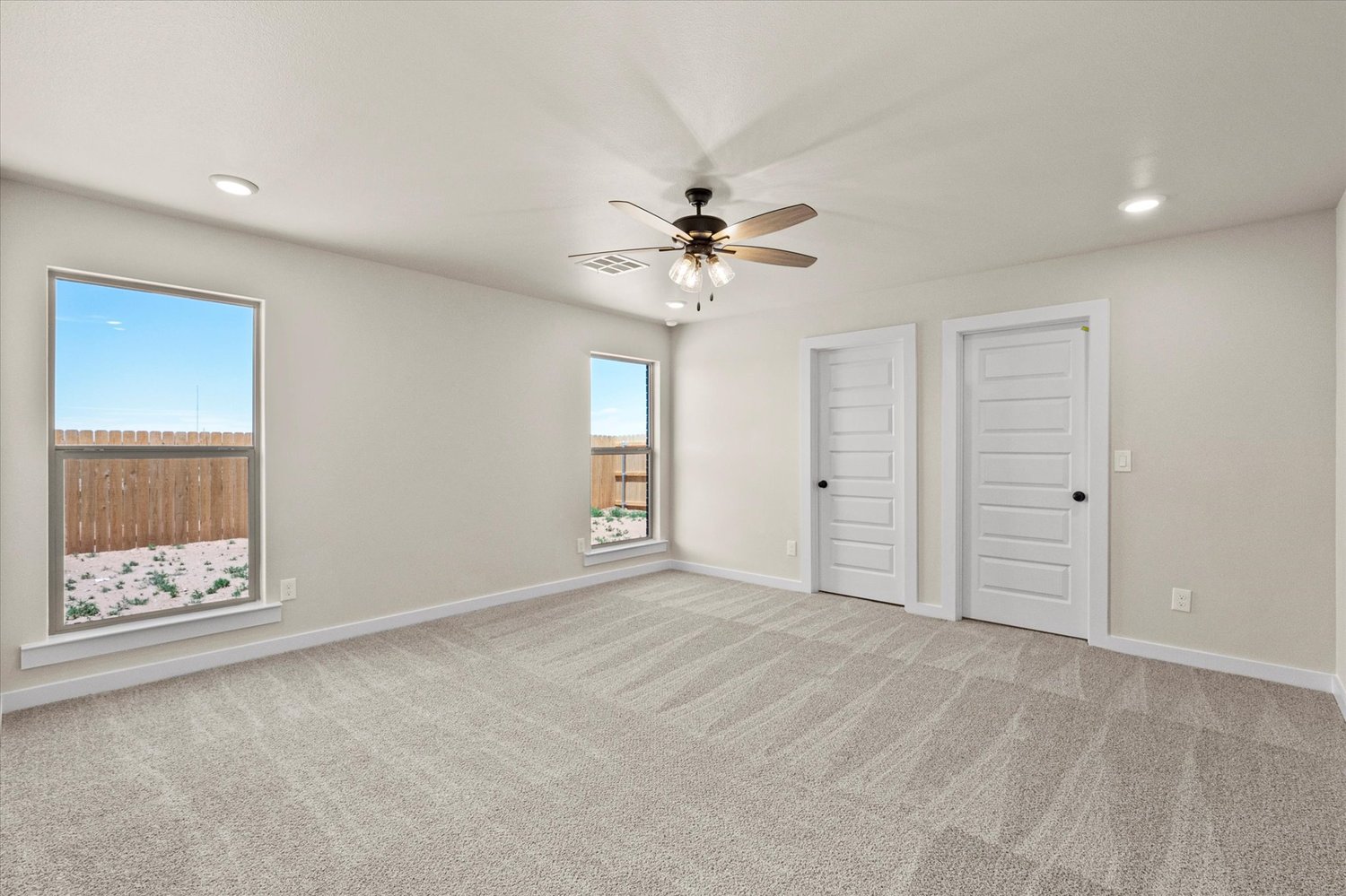 Photo of bedroom with ceiling fan in the Dorris, one of Betenbough's homes with a walk-in closet.