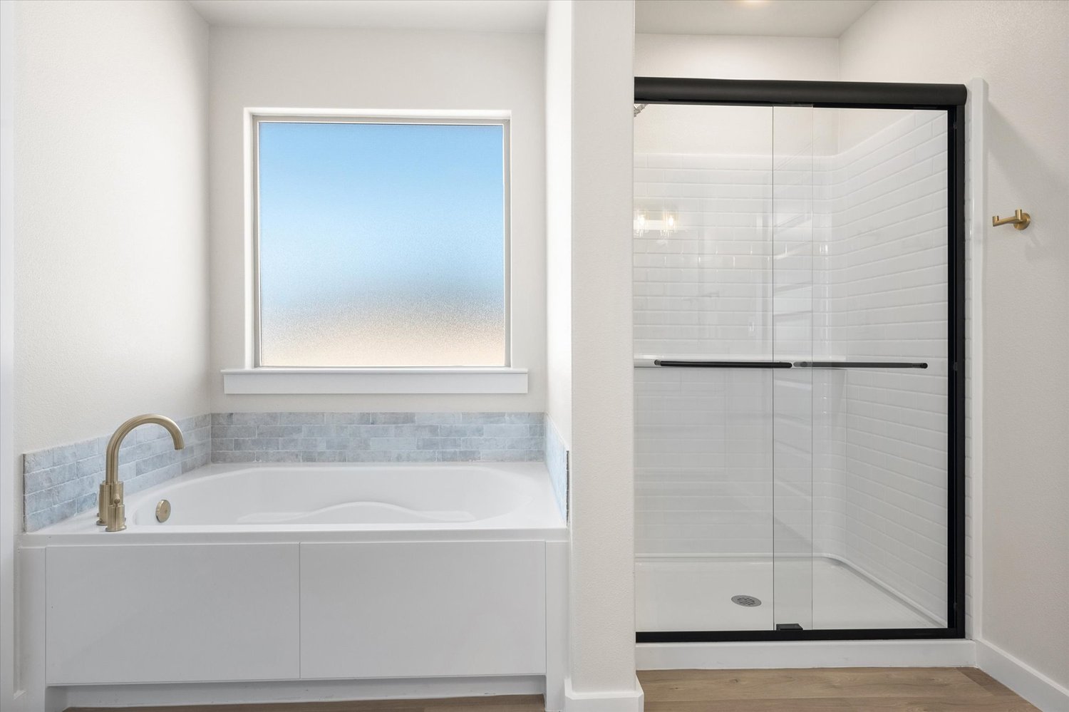 Photo of garden tub & walk-in shower in the Nikki, a Betenbough Homes floor plan.