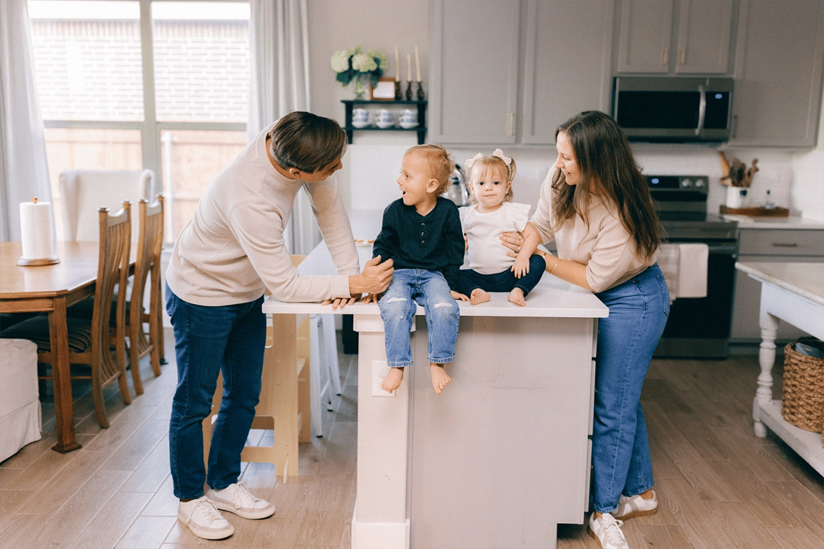 Happy family sitting on top of kitchen counter