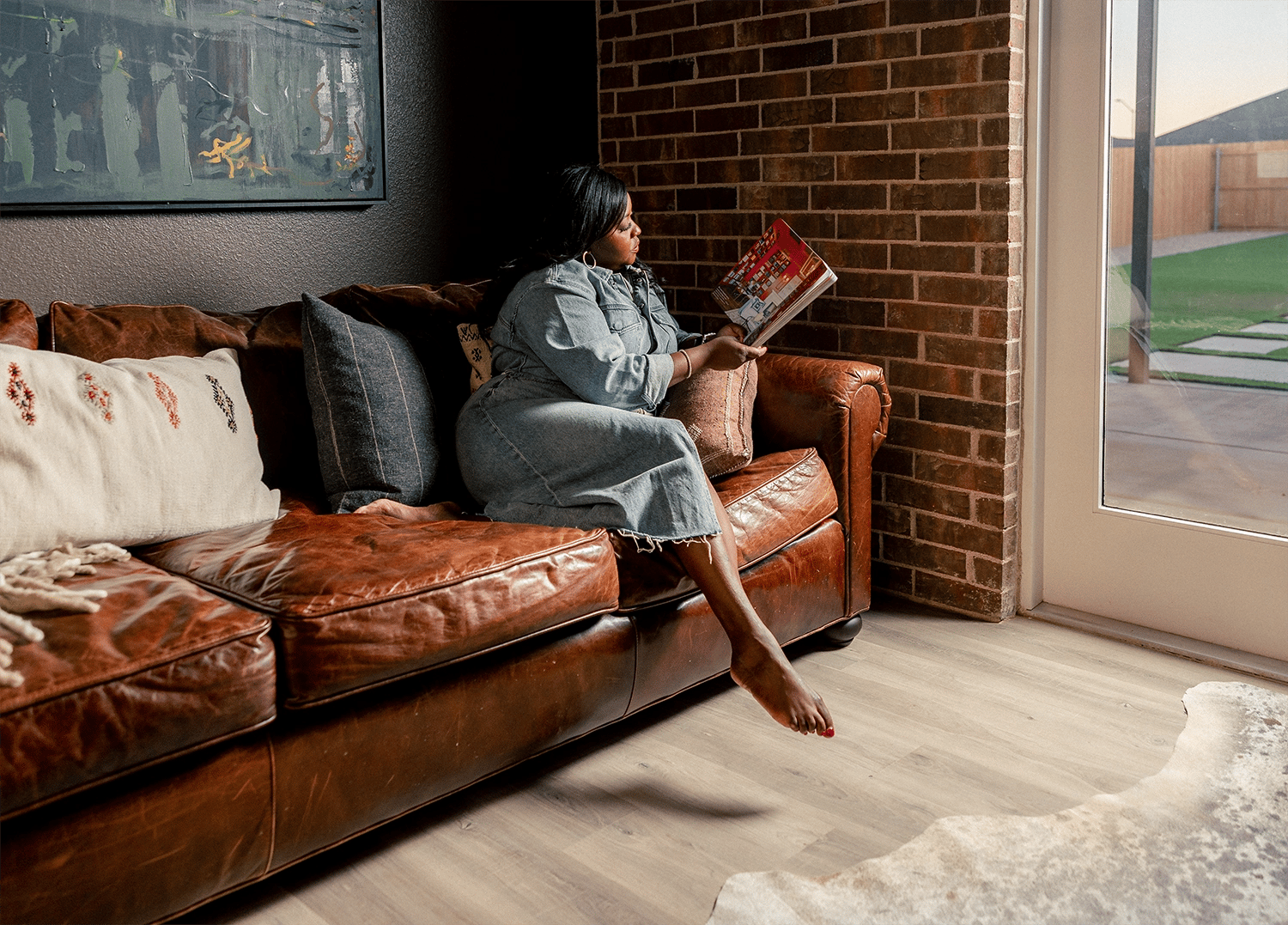 Woman reading book in brick bonus room