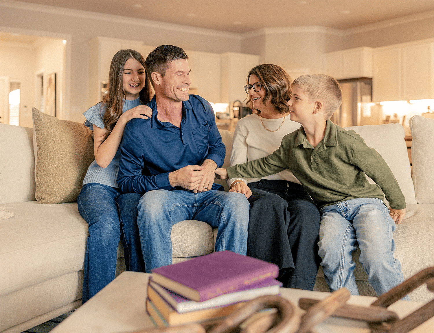 Family laughing together on couch