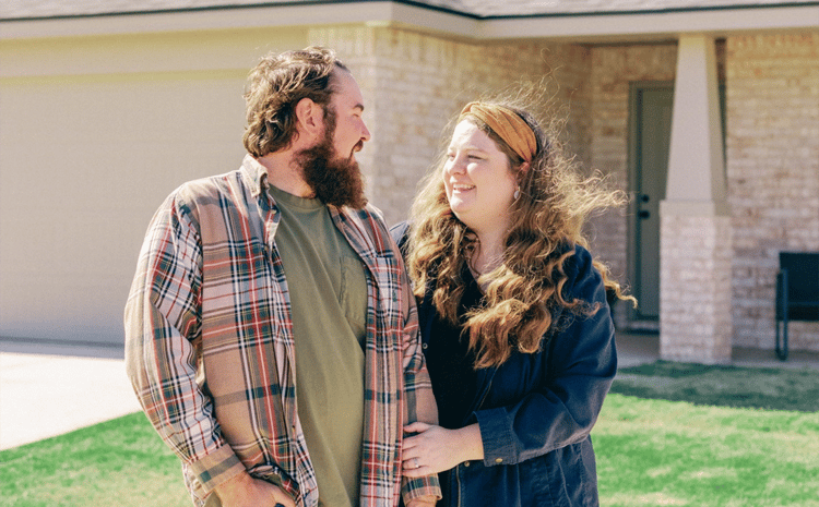 Photo of a couple outside their Betenbough home. Betenbough Homes is one of several new home builders in Lubbock Tx.