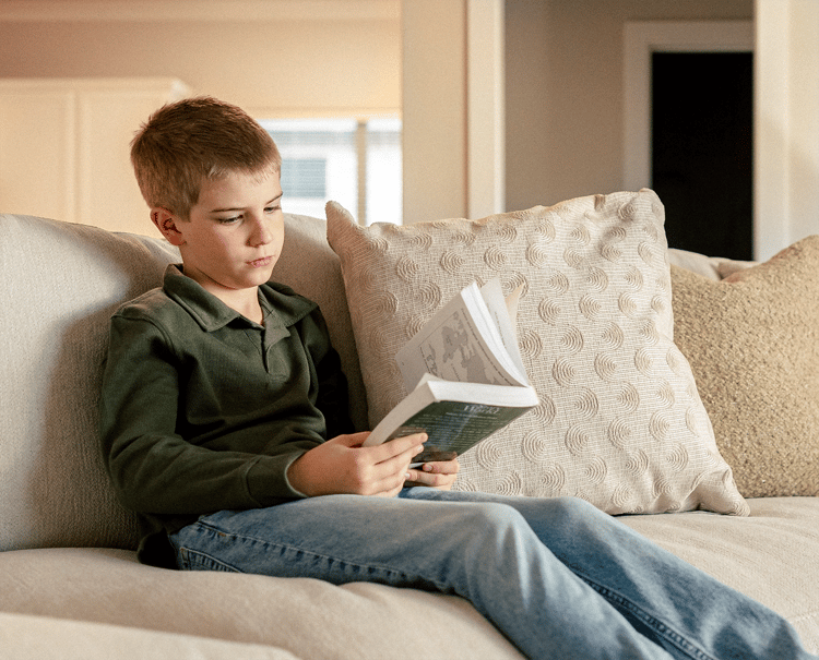 Boy sitting on the couch reading