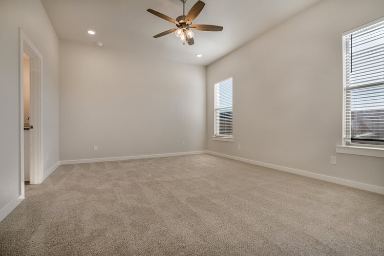 Photo of a bedroom in the Layla, one of Betenbough's homes with walk-in closets