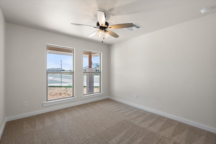 Photo of bedroom with ceiling fan in the Nikki, a Betenbough Homes floor plan.