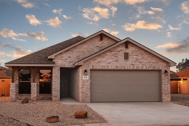 Photo of the exterior front yard of the Paisley, one of Betenbough's homes with a 2 car garage