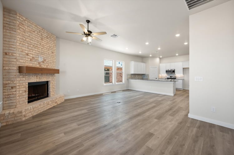 Photo of living are and fireplace in the Nikki, one of Betenbough's homes with open floor plan.