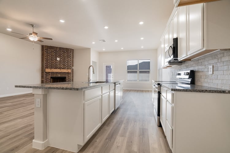 Photo of the kitchen with a view to the living and dining areas in the Layla, a Betenbough home