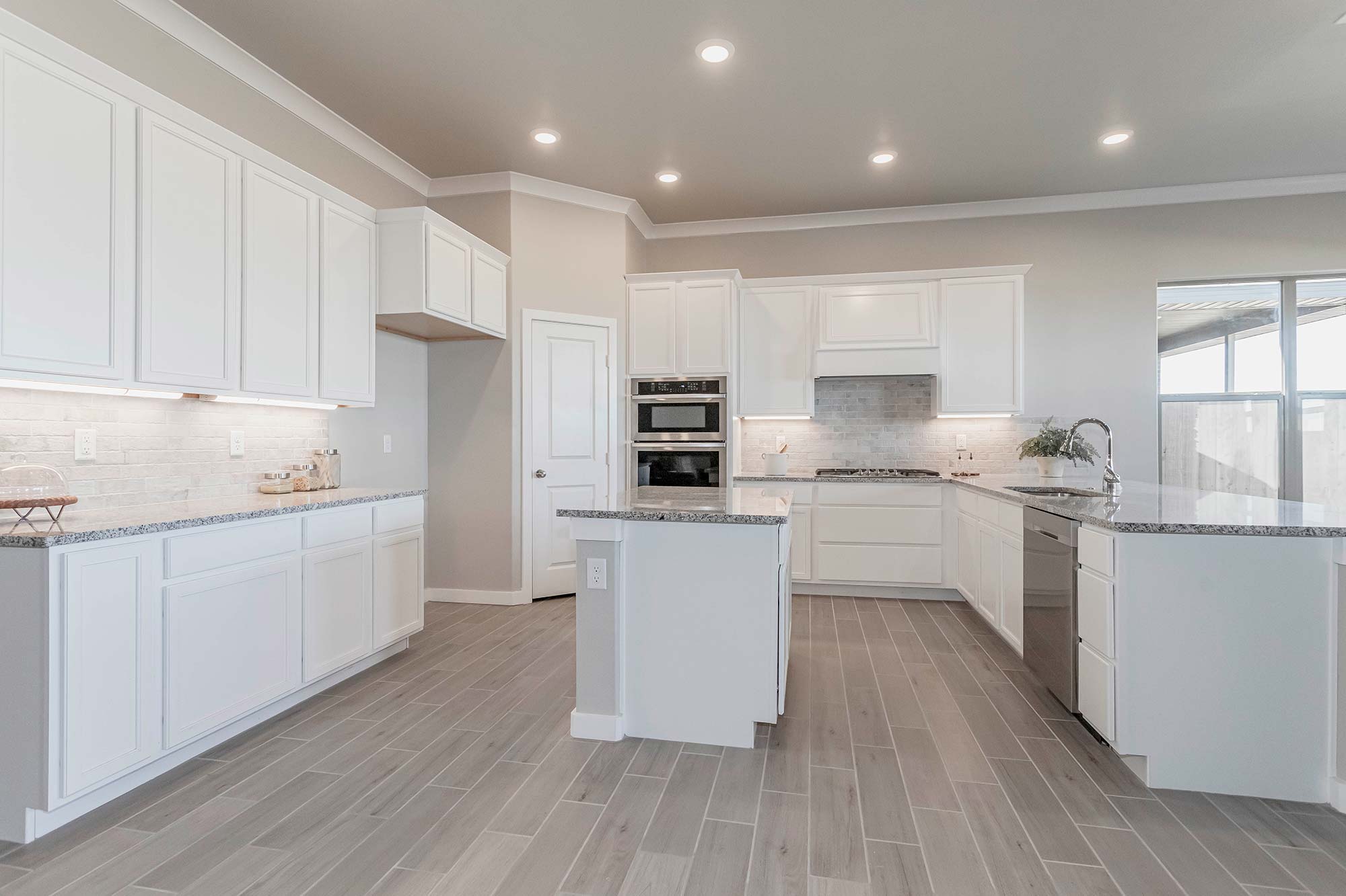 Betenbough Homes kitchen with white cabinets.