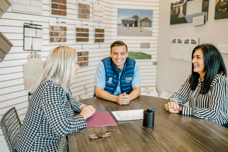 Photo of home buyer choosing new home options with the Betenbough Homes team.