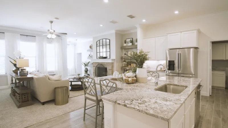 Photo of the new model home with a staged living room and kitchen.