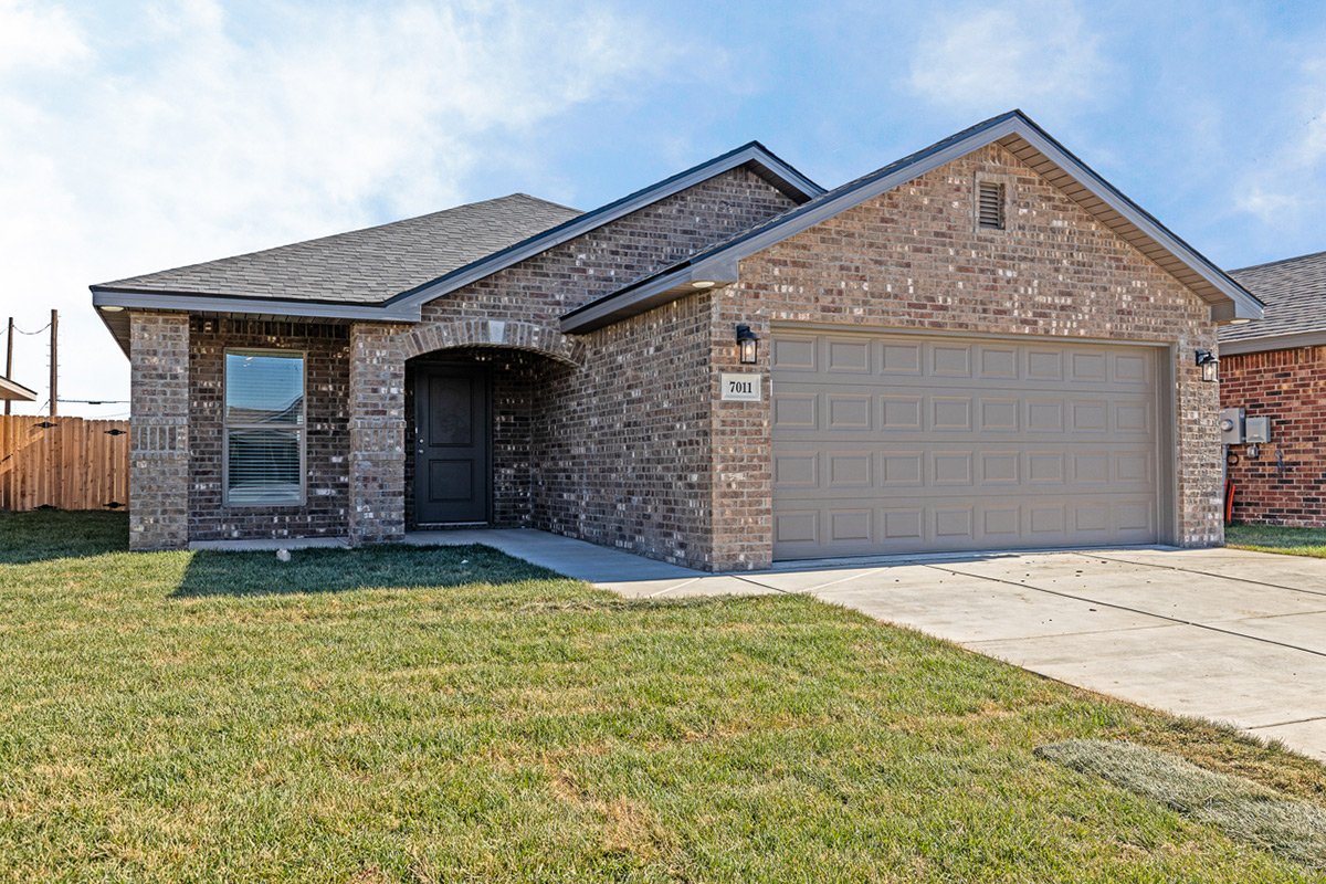 Photo of exterior of a Betenbough Home featuring a beautifully crafted arch over the front door..