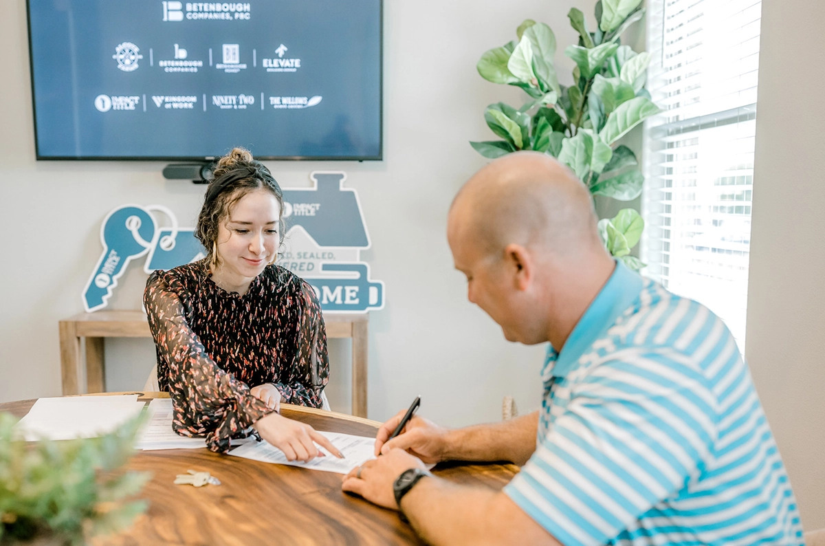 Homeowner signing papers to invest in a home