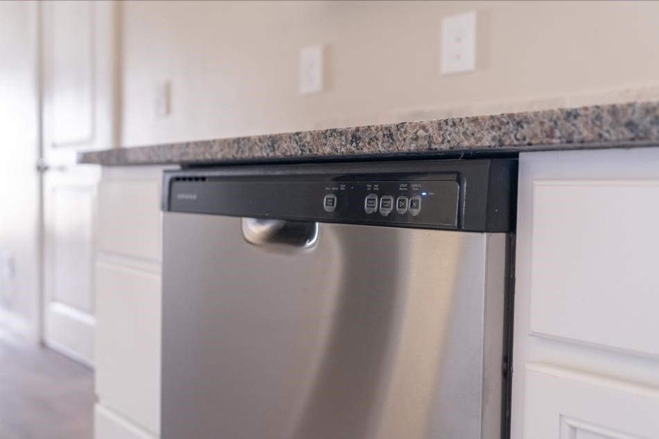 Photo of a dishwasher in a Betenbough Home representing proper cleaning and maintenance of this appliance.