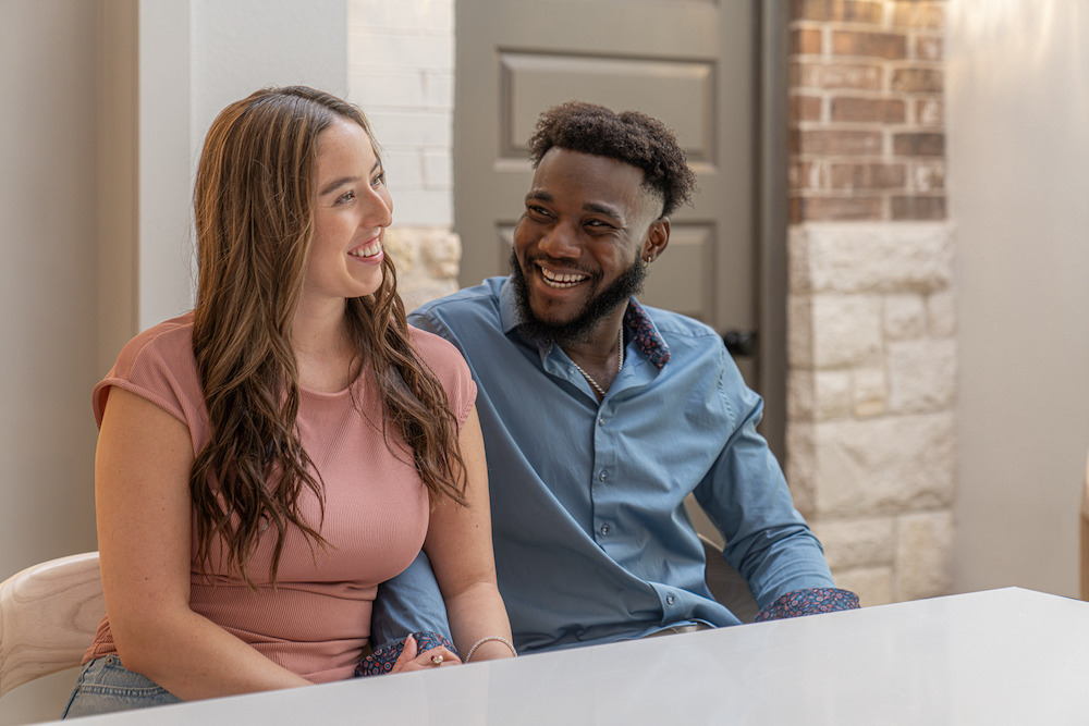 Betenbough Home owners smiling at each other in new home