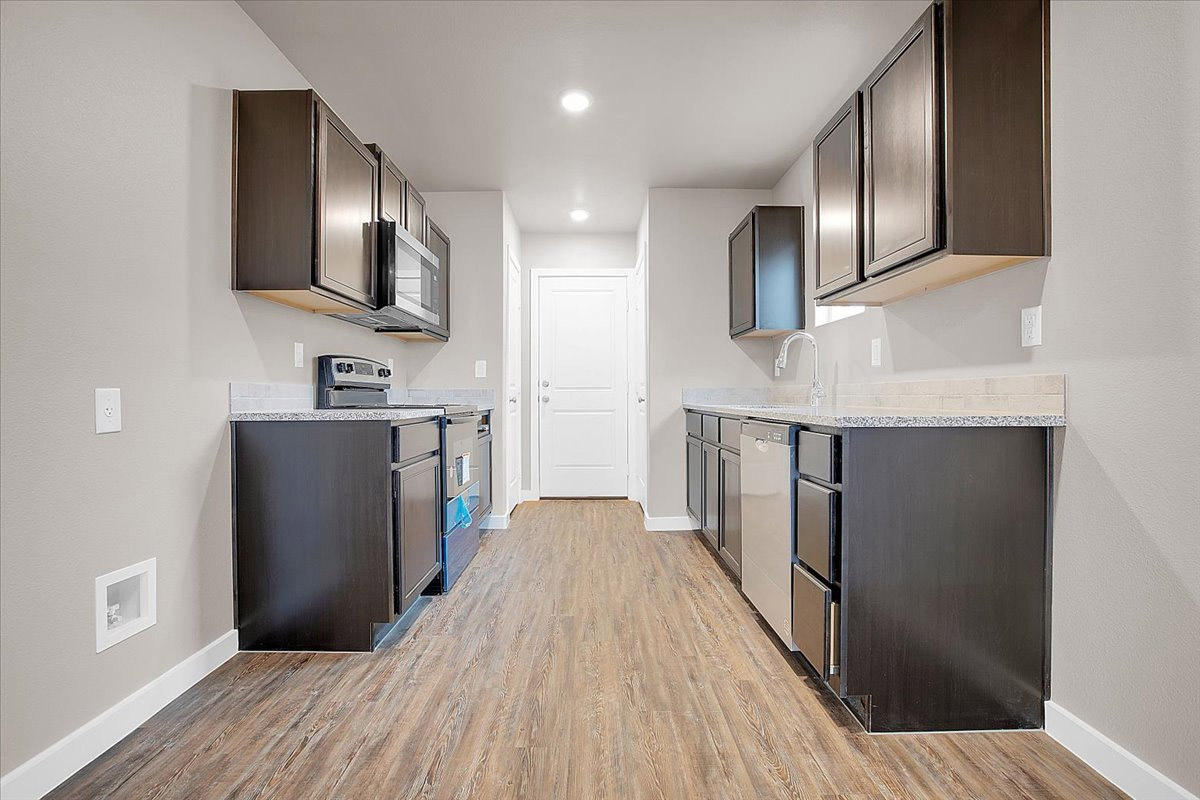 Photo of a kitchen in a smaller Betenbough home.