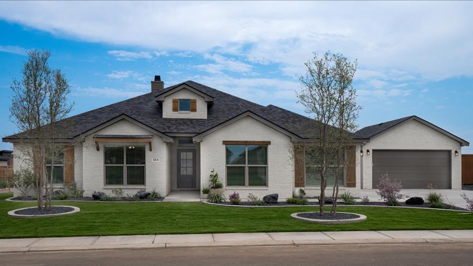 Photo of Betenbough Homes' 2024 Lubbock Parade Home. This Heidi floor plan boasts painted brick, cedar awnings and shutters, a double gable roof, and a dormer. It has a side-entry garage with a separate, detached garage as well.