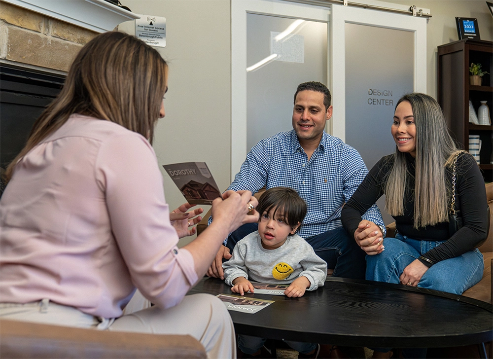 Photo of a Betenbough Homes employee greeting a home buyer.