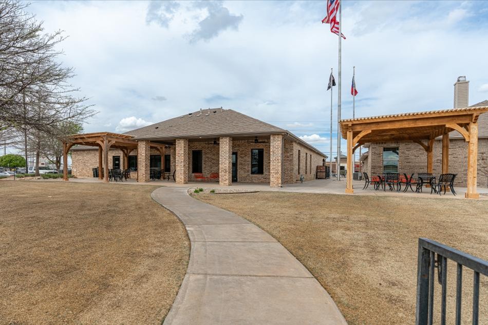 Photo of Betenbough Homes New Home Center with flags flying.