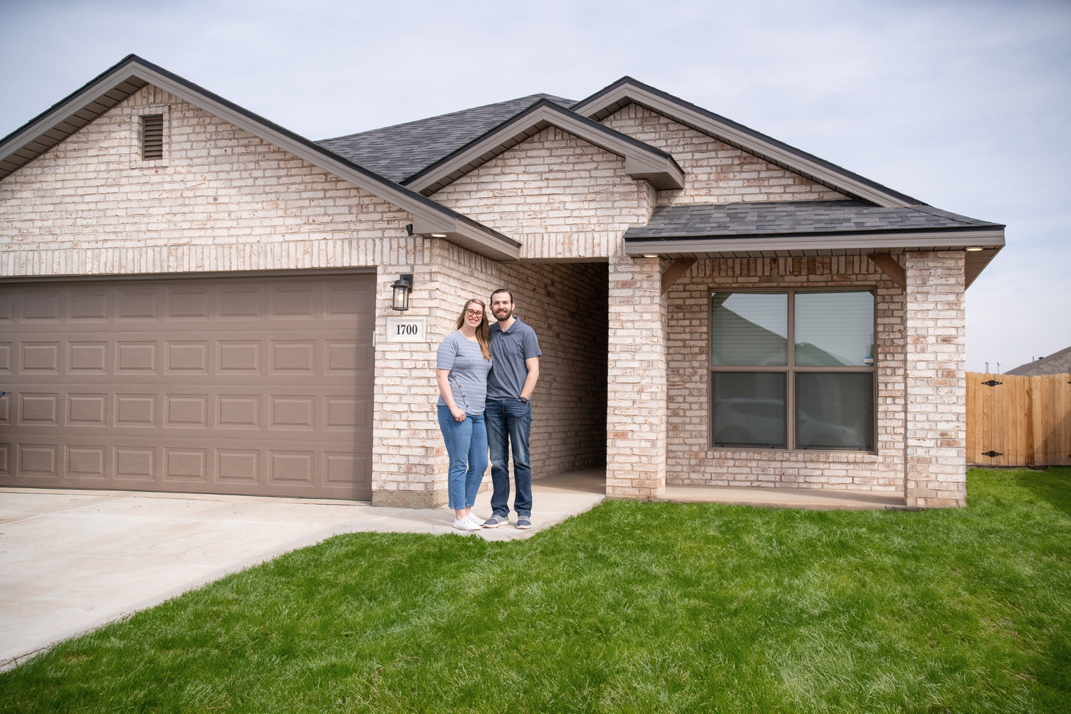 Couple standing in front of their Betenbough home