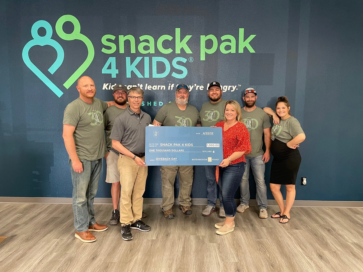 Betenbough employees giving check to Snack Pak for Kids