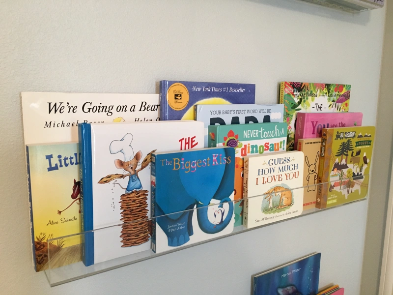 Photo of baby books arranged on handy acrylic shelves.