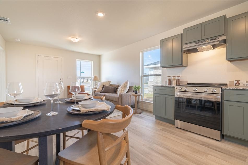 Open kitchen and dining area inside a Betenbough Origin Collection home