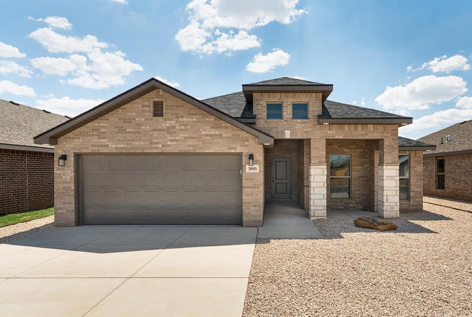 Photo of the exterior of a Betenbough Home with xeriscaping and a blue sky.