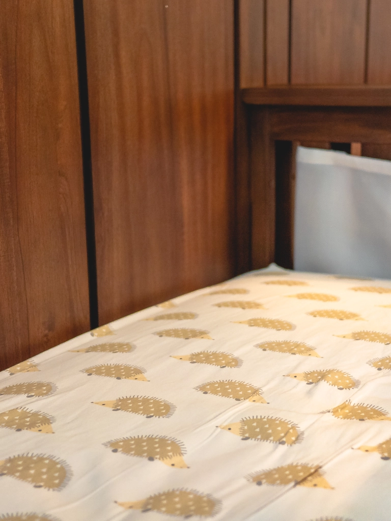 Photo of hedgehog crib sheets on a crib.