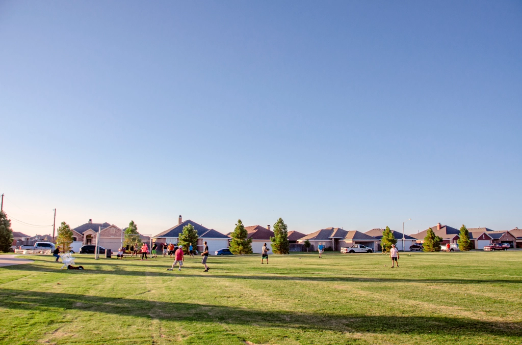 Photo of kids playing baseball in a community park.