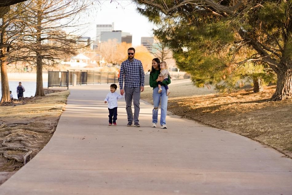 Photo of a family walking along a waterway with the Midland skyline in the background.