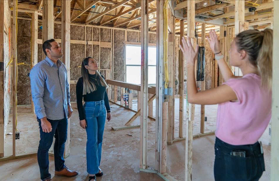 Photo of a Betenbough Homes employee giving a frame tour.