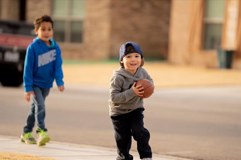 Photo of children playing football in a Betenbough Homes community.