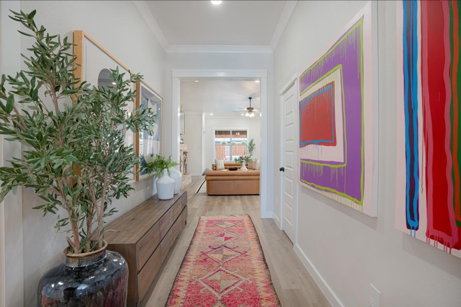 Photo of a decorated hallway leading into the living room in a Betenbough home.