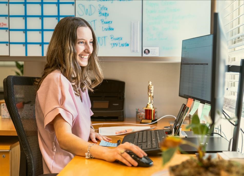 Photo of an employee working at her desk.