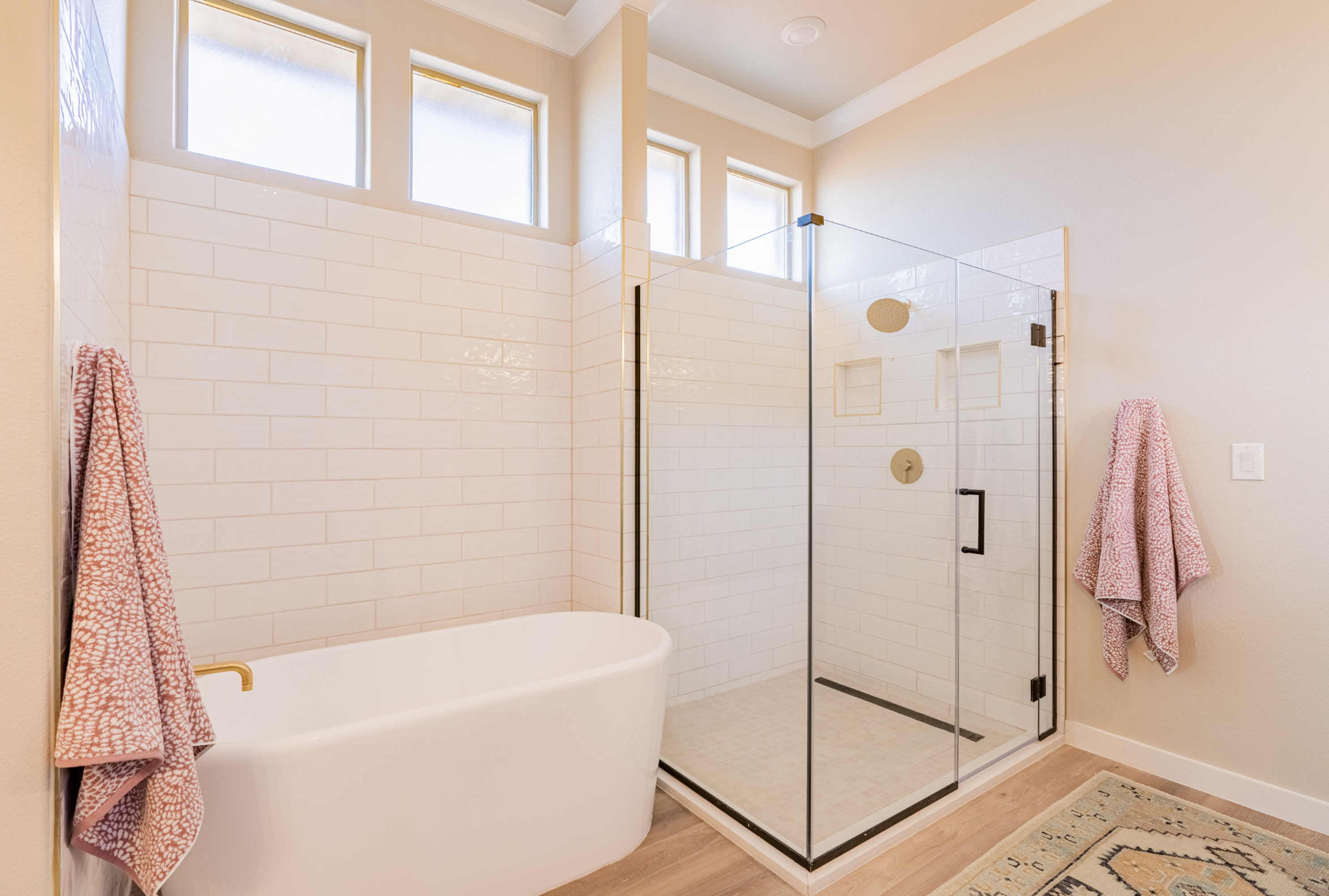 Photo of the Parade Home's master bathroom with a glass shower and free-standing tub.