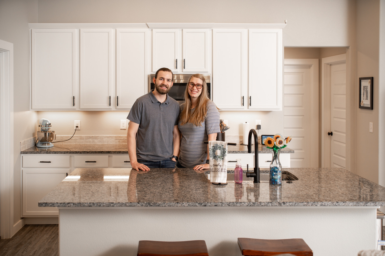 Photo of a couple in their kitchen build by Betenbough Homes, a new home builder in West Texas.